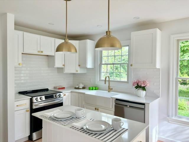 2850 Reeve Rd, Mattituck, NY 11952 - kitchen with stainless steel appliances, a sink, light countertops, and white cabinets