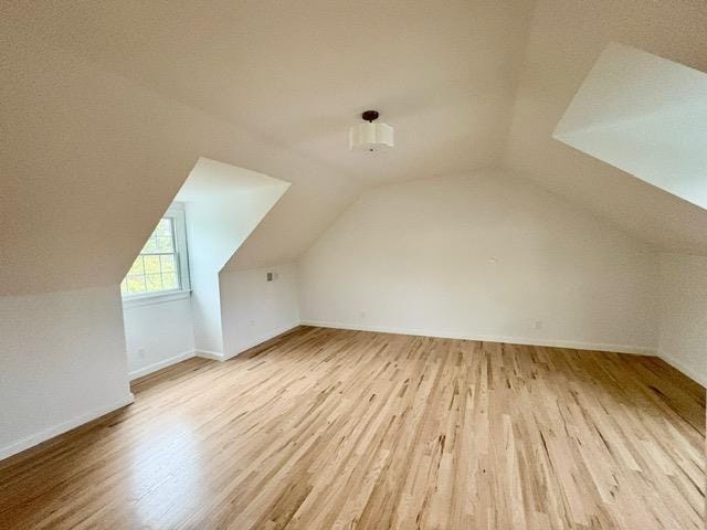 2850 Reeve Rd, Mattituck, NY 11952 - additional living space with wood finished floors, vaulted ceiling, and baseboards