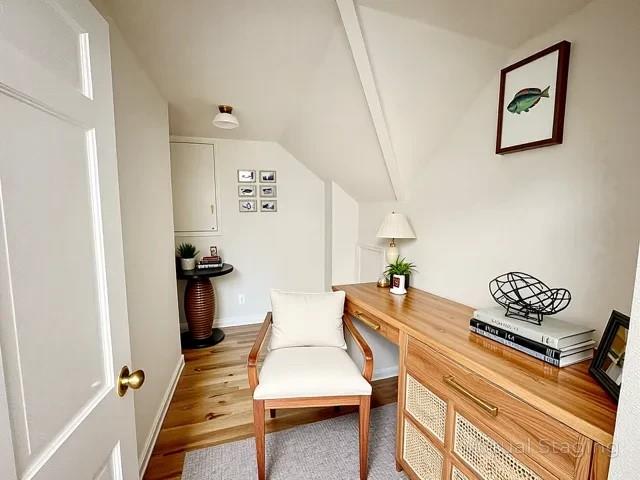 2850 Reeve Rd, Mattituck, NY 11952 - living area with lofted ceiling, an office area, wood finished floors, and baseboards