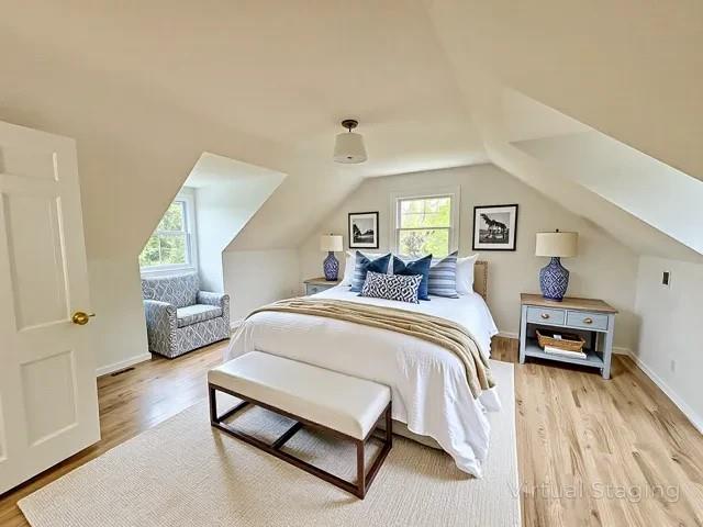 2850 Reeve Rd, Mattituck, NY 11952 - bedroom with multiple windows, light wood-type flooring, and lofted ceiling