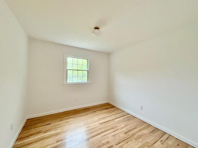 2850 Reeve Rd, Mattituck, NY 11952 - spare room featuring light wood-style flooring and baseboards
