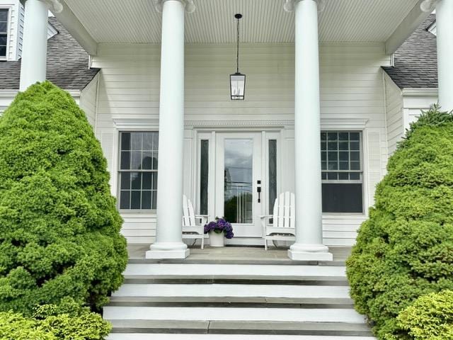 2850 Reeve Rd, Mattituck, NY 11952 - view of exterior entry with covered porch and a shingled roof