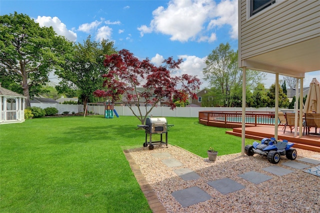 view of yard featuring a playground and a deck