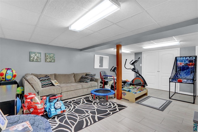 living room featuring a paneled ceiling