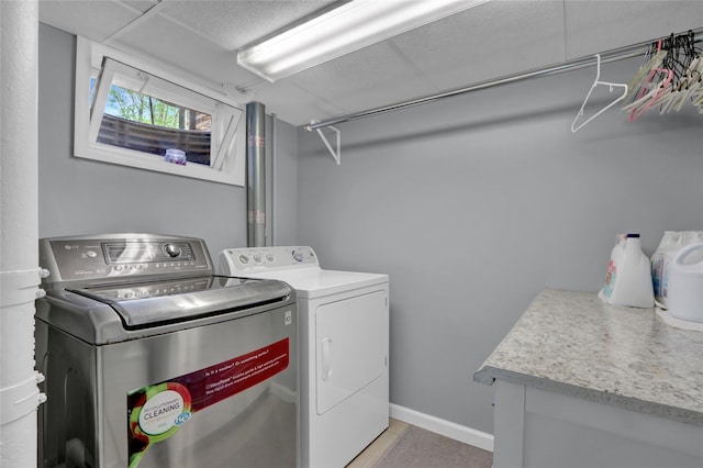 laundry area featuring independent washer and dryer and baseboards