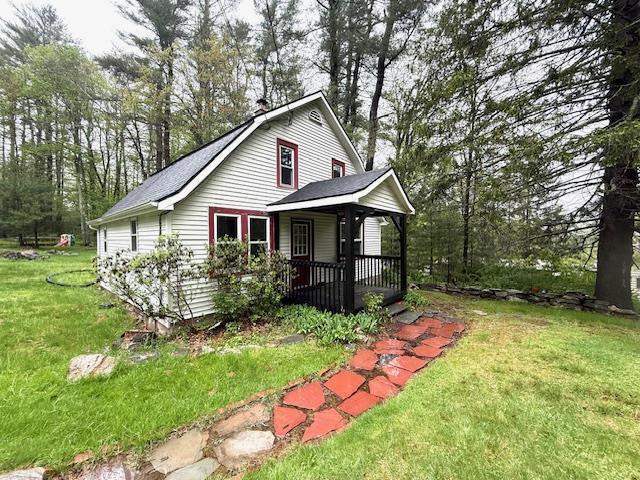 38 Eldred Yulan Rd, Eldred, NY 12732 - view of side of property featuring covered porch, a lawn, a gambrel roof, and view of wooded area