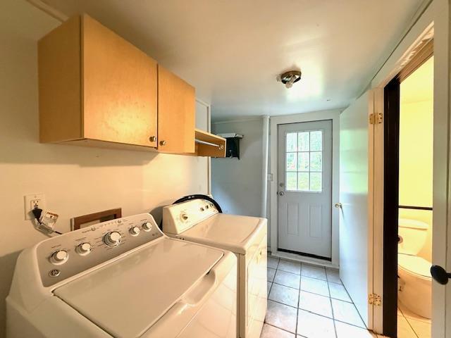 38 Eldred Yulan Rd, Eldred, NY 12732 - washroom featuring cabinet space, washing machine and clothes dryer, and light tile patterned flooring