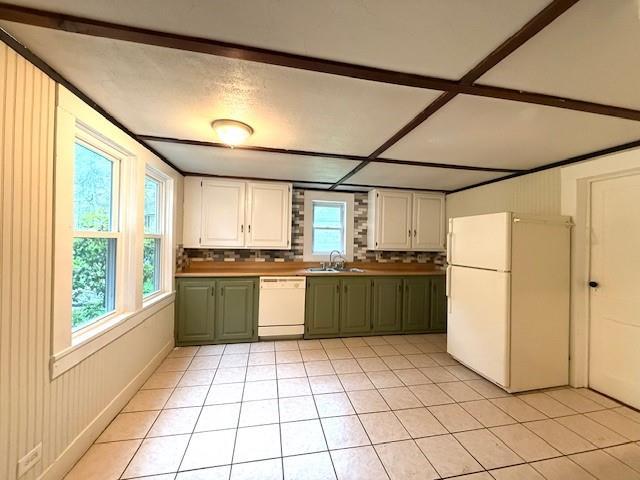 38 Eldred Yulan Rd, Eldred, NY 12732 - kitchen featuring white appliances, a sink, green cabinetry, light tile patterned floors, and white cabinets