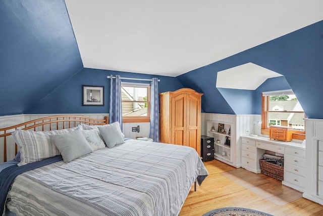 27 Amby Ave, Plainview, NY 11803 - bedroom featuring vaulted ceiling, light wood-style floors, multiple windows, and wainscoting