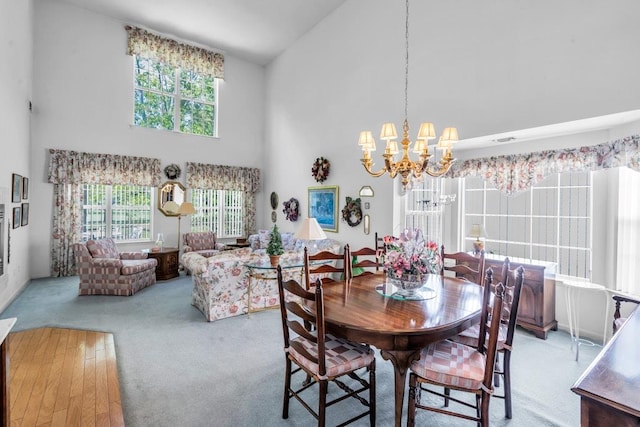 30 Julia Cir, Middle Island, NY 11953 - carpeted dining space featuring high vaulted ceiling and a chandelier