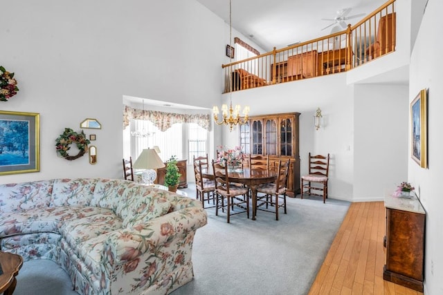 30 Julia Cir, Middle Island, NY 11953 - living room with a towering ceiling, wood-type flooring, ceiling fan, a chandelier, and baseboards