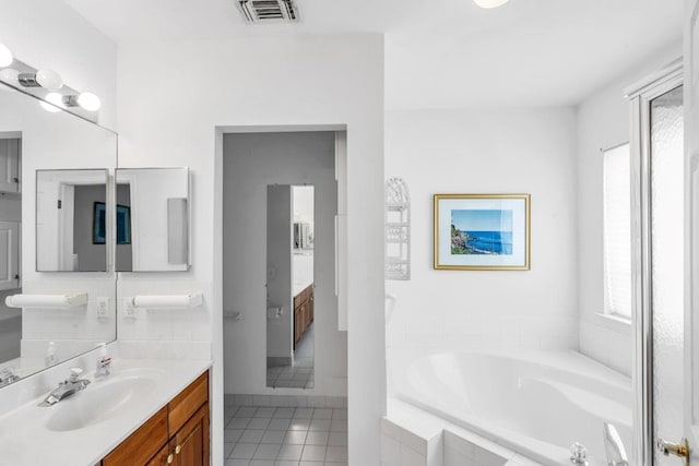 30 Julia Cir, Middle Island, NY 11953 - full bath with tile patterned flooring, a garden tub, healthy amount of natural light, and vanity