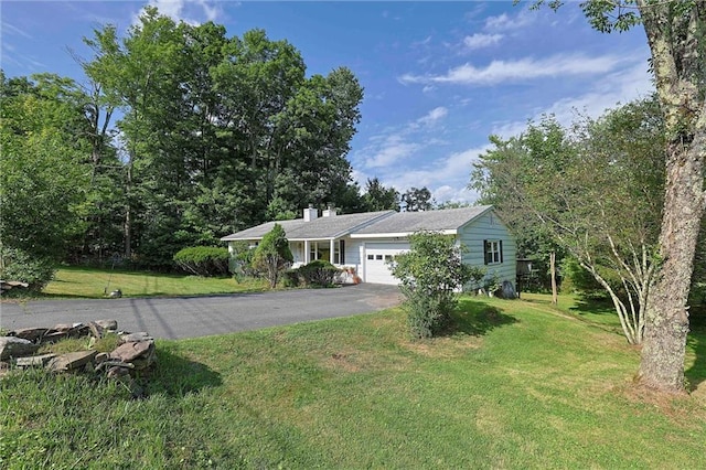 198 Dillon Rd, Monticello, NY 12701 - view of front of home with a garage, a front yard, driveway, and a chimney