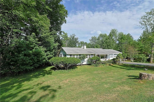 198 Dillon Rd, Monticello, NY 12701 - view of front of property with a front lawn, a chimney, and driveway