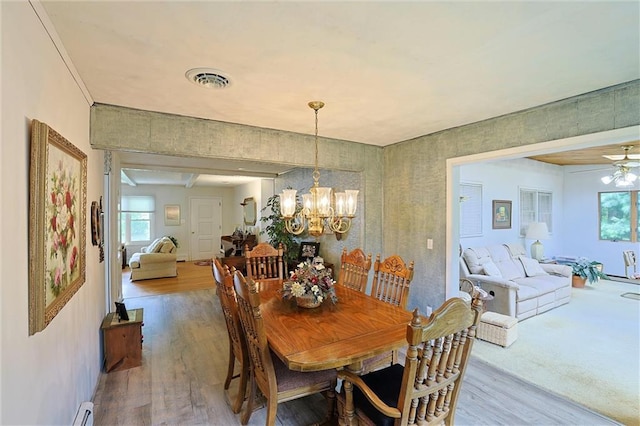 198 Dillon Rd, Monticello, NY 12701 - dining space with wood finished floors, healthy amount of natural light, a chandelier, and baseboards