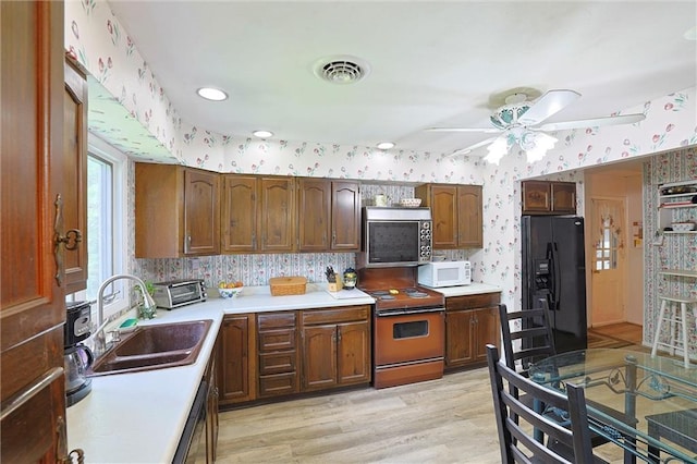 198 Dillon Rd, Monticello, NY 12701 - kitchen featuring black fridge, wallpapered walls, white microwave, stainless steel microwave, and electric stove