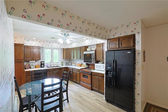 198 Dillon Rd, Monticello, NY 12701 - kitchen featuring black appliances, wallpapered walls, a sink, a ceiling fan, and light countertops
