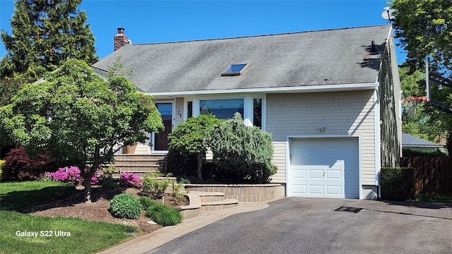 26 Tioga Dr, Jericho, NY 11753 - view of front of property with an attached garage, a chimney, asphalt driveway, and roof with shingles