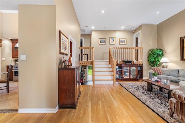 26 Tioga Dr, Jericho, NY 11753 - living area featuring light wood-style flooring, baseboards, recessed lighting, and stairway