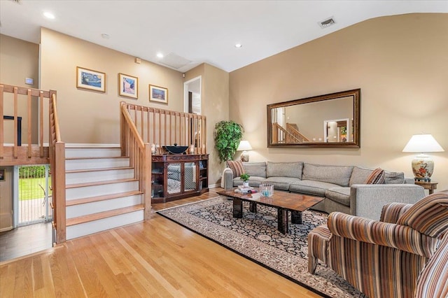 26 Tioga Dr, Jericho, NY 11753 - living room featuring wood finished floors, stairs, and recessed lighting