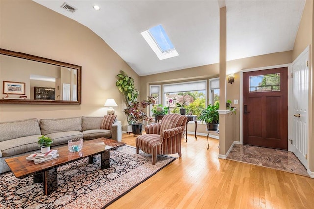 26 Tioga Dr, Jericho, NY 11753 - living room with lofted ceiling, light wood-style flooring, healthy amount of natural light, a skylight, and baseboards