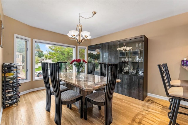 26 Tioga Dr, Jericho, NY 11753 - dining area with a chandelier, baseboards, and light wood-style floors