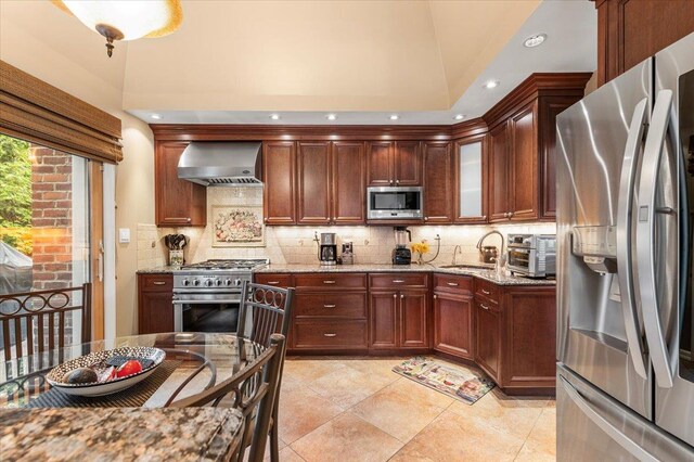26 Tioga Dr, Jericho, NY 11753 - kitchen featuring stainless steel appliances, wall chimney range hood, backsplash, recessed lighting, and light stone counters