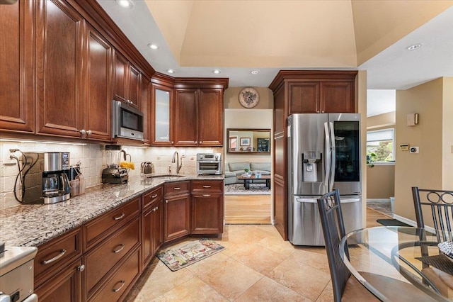 26 Tioga Dr, Jericho, NY 11753 - kitchen with stainless steel appliances, backsplash, recessed lighting, light stone counters, and glass insert cabinets
