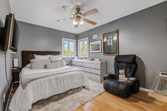 26 Tioga Dr, Jericho, NY 11753 - bedroom with wood finished floors, a ceiling fan, and baseboards