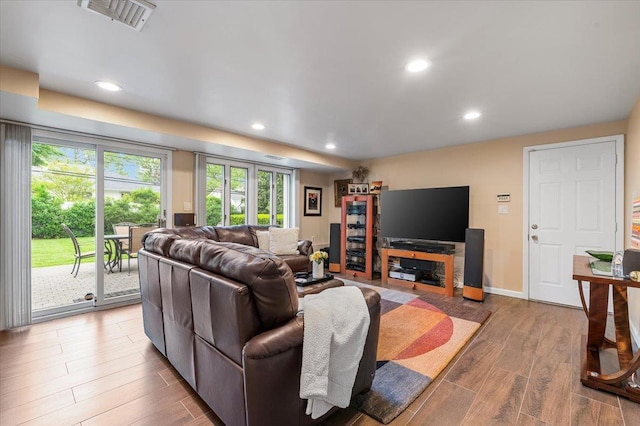 26 Tioga Dr, Jericho, NY 11753 - living room with wood finished floors, recessed lighting, and baseboards
