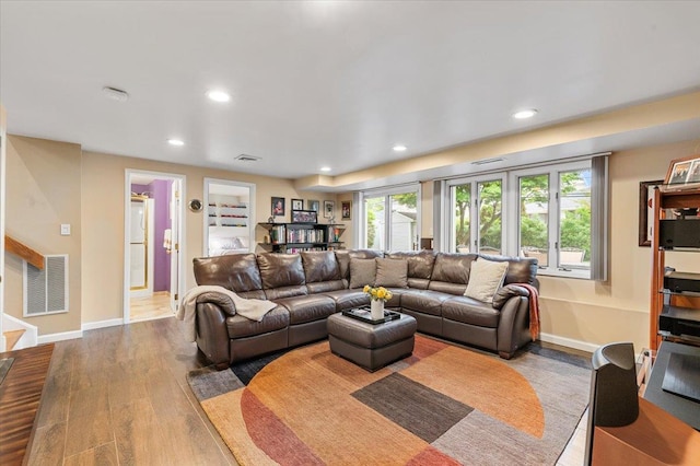 26 Tioga Dr, Jericho, NY 11753 - living area with wood finished floors, recessed lighting, and baseboards