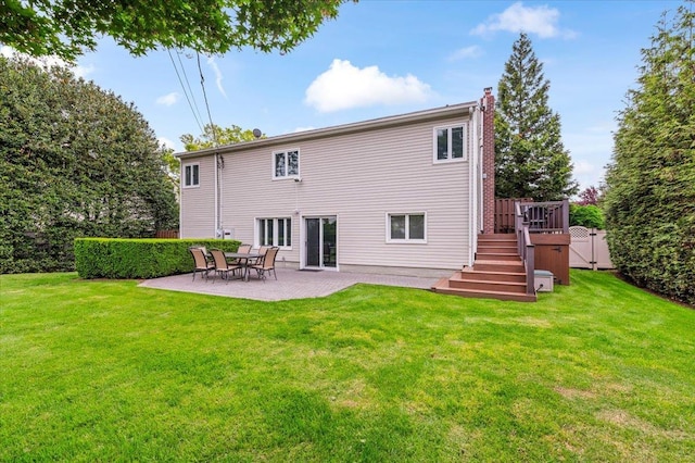 26 Tioga Dr, Jericho, NY 11753 - back of property featuring a chimney, a patio area, a yard, stairs, and a deck
