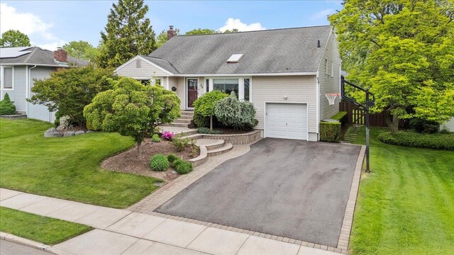 26 Tioga Dr, Jericho, NY 11753 - view of front of property featuring asphalt driveway, a front lawn, a chimney, and a garage
