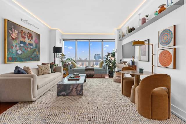 living area featuring baseboards and crown molding