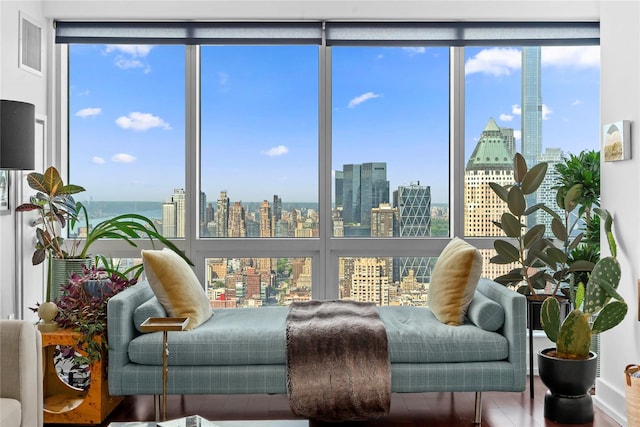 sitting room with a view of skyline and wood finished floors
