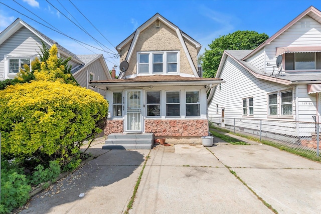 119-64 177th St, Saint Albans, NY 11434 - colonial inspired home featuring stone siding, fence, and a gambrel roof