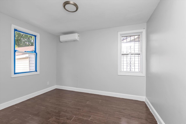 119-64 177th St, Saint Albans, NY 11434 - spare room with an AC wall unit, dark wood-style floors, and baseboards