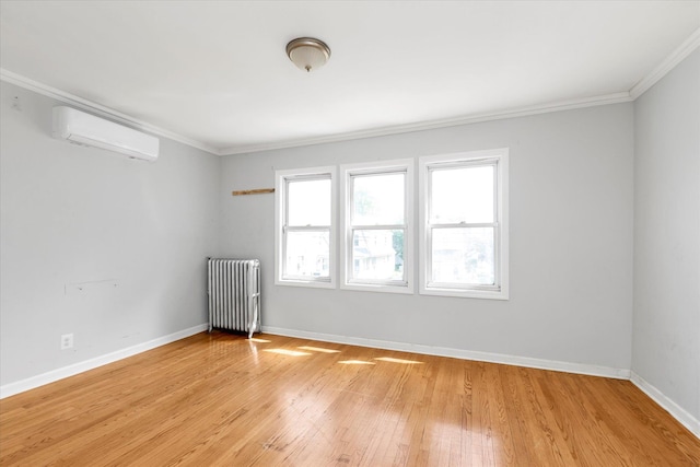 119-64 177th St, Saint Albans, NY 11434 - spare room featuring radiator, an AC wall unit, crown molding, light wood-style flooring, and baseboards