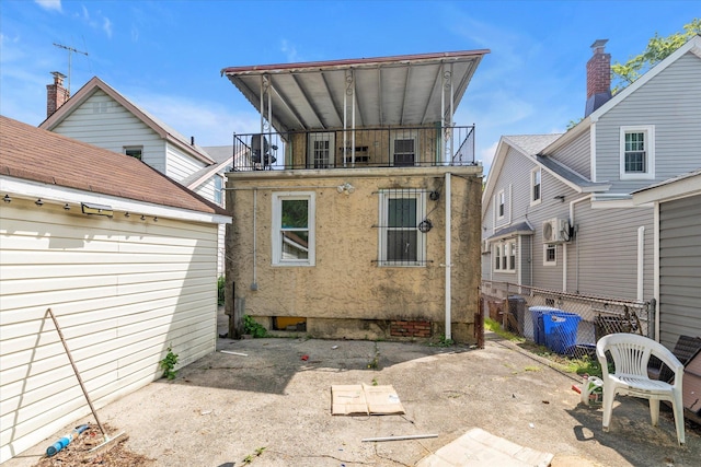 119-64 177th St, Saint Albans, NY 11434 - rear view of property featuring a balcony, fence, and stucco siding