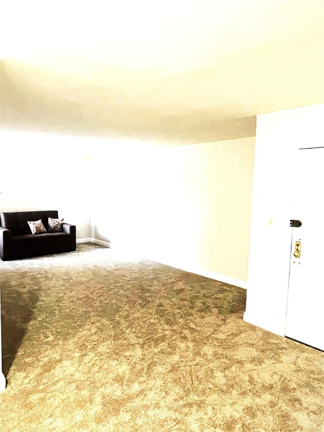 88-10 32nd Ave Unit 201, East Elmhurst, NY 11369 - unfurnished living room featuring carpet and baseboards