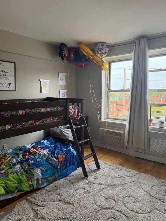 20 Wendell St Unit 9E, Hempstead, NY 11550 - bedroom with wood finished floors and an AC wall unit