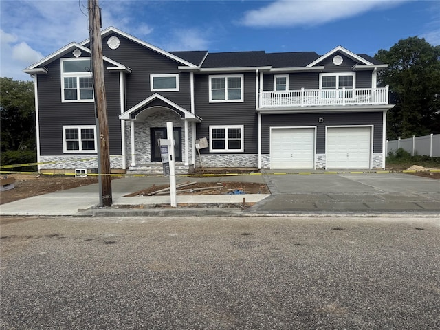 139 Miller Ave SW, Amityville, NY 11701 - view of property featuring a balcony, driveway, stone siding, and a garage