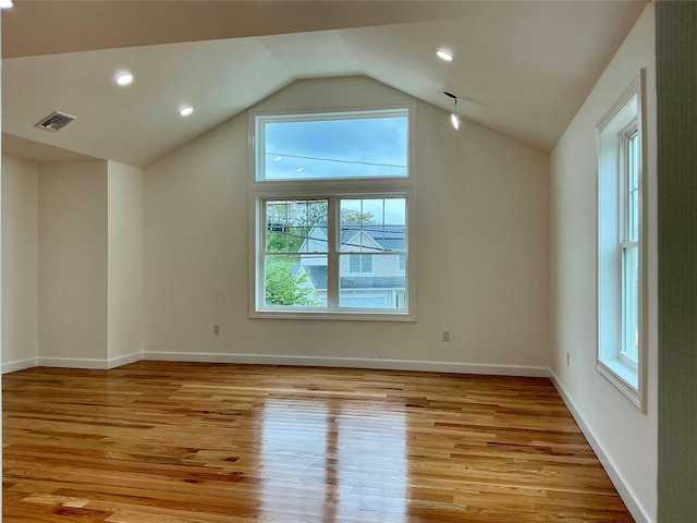 139 Miller Ave SW, Amityville, NY 11701 - additional living space with healthy amount of natural light, light wood-style flooring, vaulted ceiling, baseboards, and recessed lighting