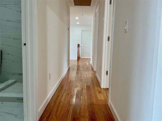 139 Miller Ave SW, Amityville, NY 11701 - corridor featuring attic access, wood finished floors, and baseboards