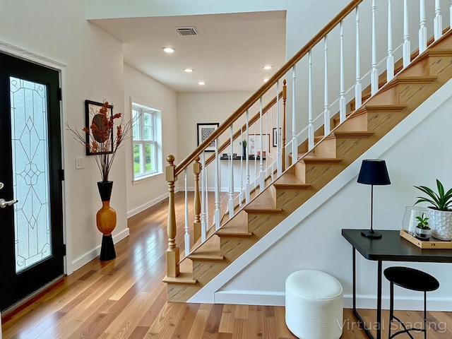 139 Miller Ave SW, Amityville, NY 11701 - foyer entrance with wood finished floors, stairway, recessed lighting, and baseboards