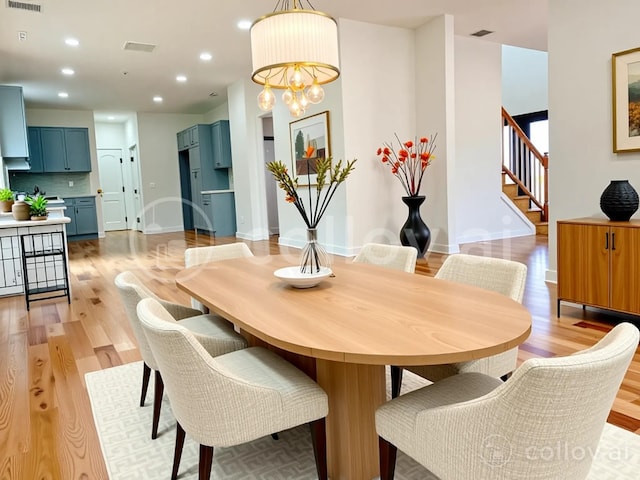 139 Miller Ave SW, Amityville, NY 11701 - dining area with stairs, light wood finished floors, recessed lighting, a chandelier, and baseboards