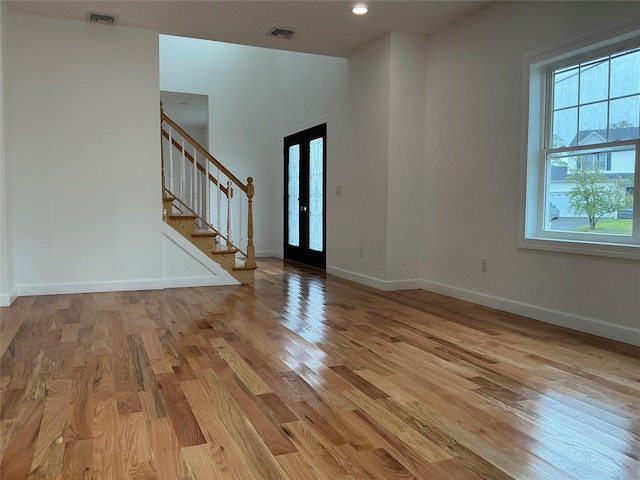139 Miller Ave SW, Amityville, NY 11701 - foyer featuring light wood-style floors, stairway, baseboards, and french doors