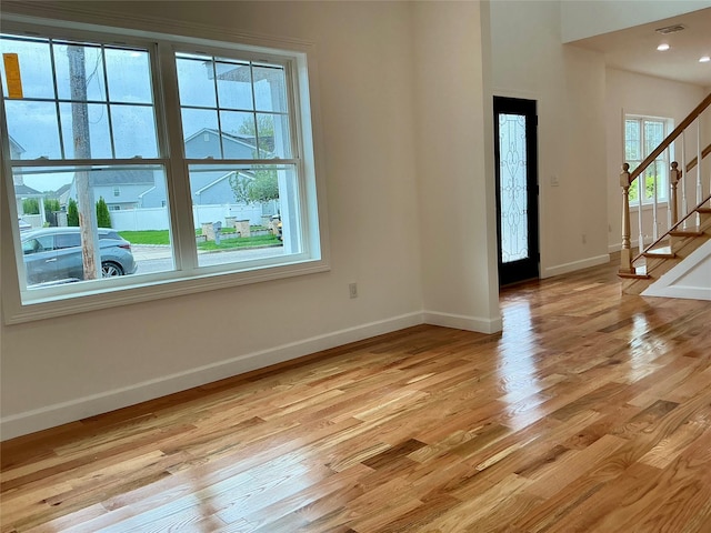 139 Miller Ave SW, Amityville, NY 11701 - foyer entrance with baseboards, stairs, and light wood-style flooring