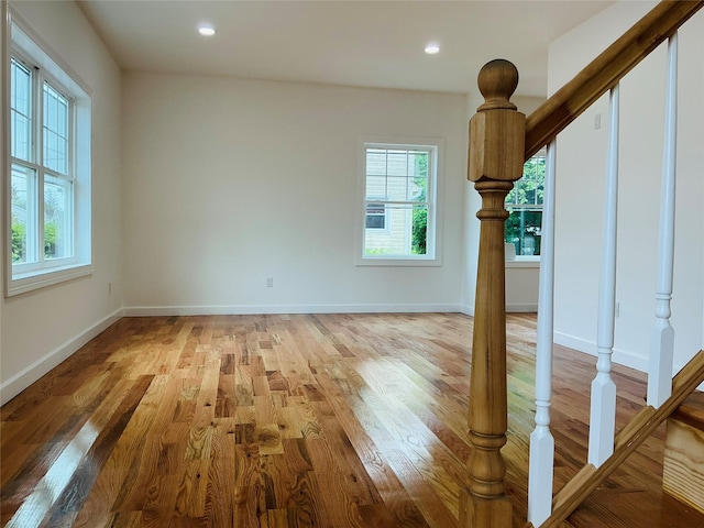 139 Miller Ave SW, Amityville, NY 11701 - unfurnished living room featuring light wood-style floors, baseboards, stairway, and recessed lighting