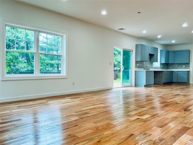 139 Miller Ave SW, Amityville, NY 11701 - unfurnished living room featuring light wood-style floors, baseboards, and recessed lighting